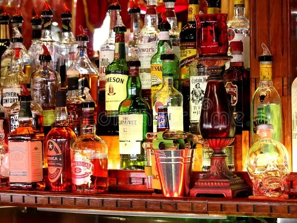 liquor-bottles-lined-up-behind-bar-keystone-south-dakota-named-red-garter-saloon-includes-various-brands-146425727